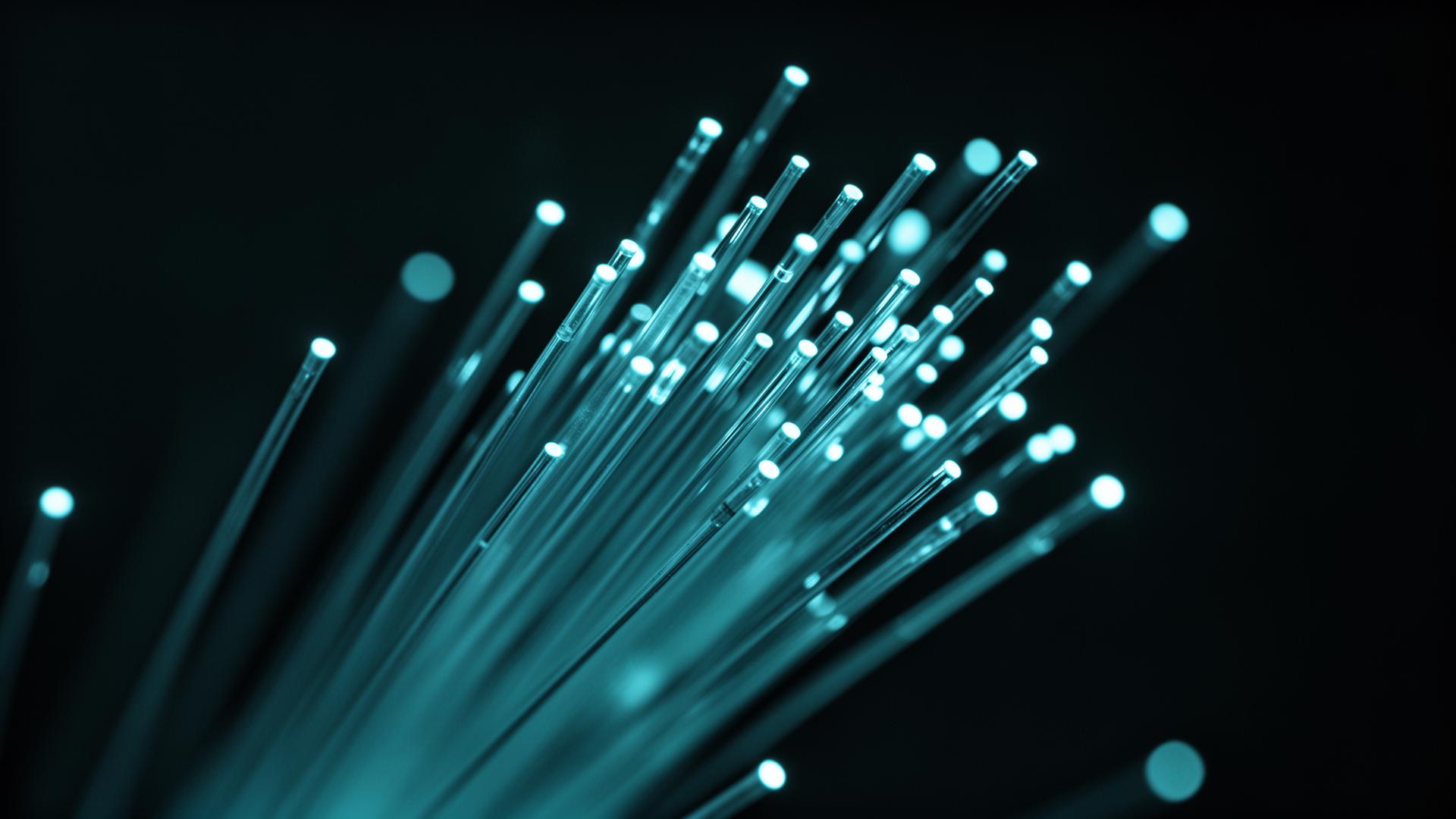 Glowing fiber optic strands carrying light, representing fiber optic training for technicians
